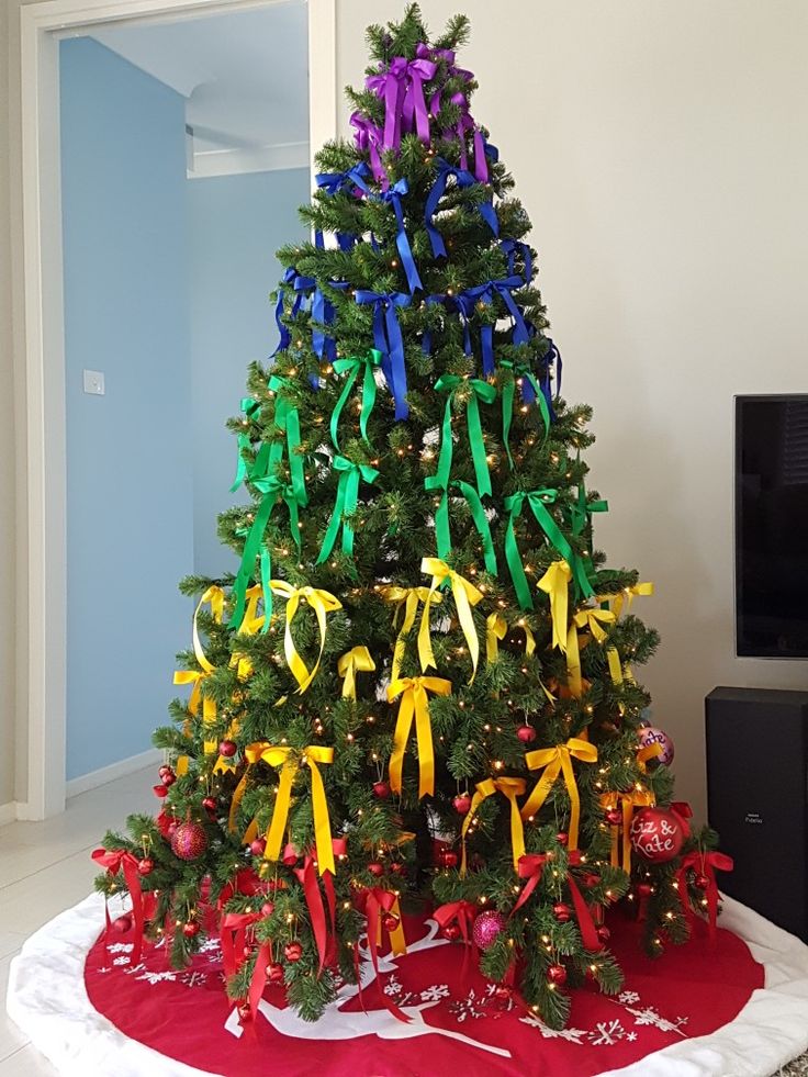 a christmas tree decorated with ribbons and bows