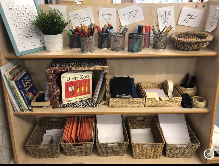 a book shelf filled with lots of books and office supplies on top of wooden shelves