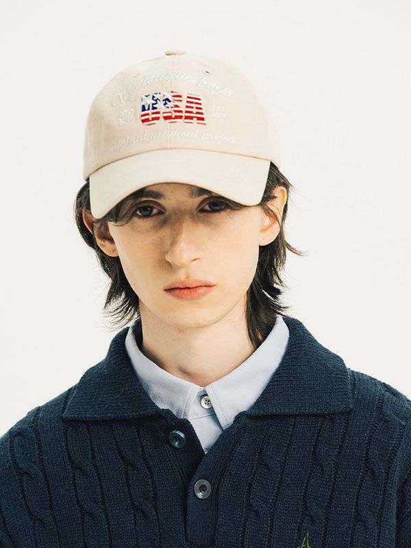 a young man wearing a hat with an american flag on the front and back of it