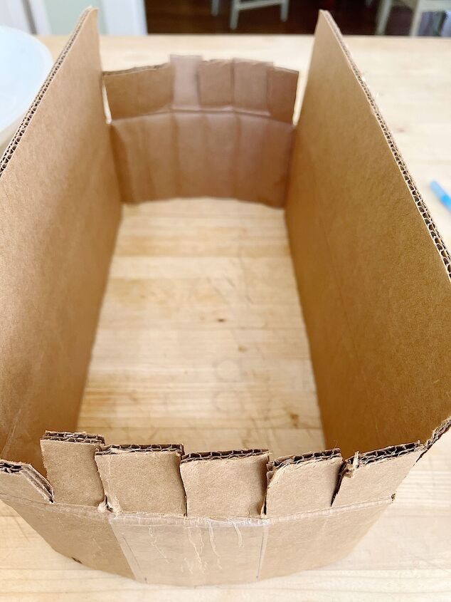 an open cardboard box sitting on top of a wooden table