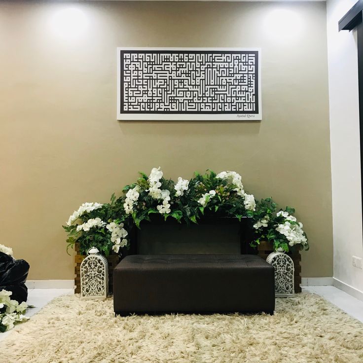 a couch sitting on top of a shaggy rug in front of a wall with white flowers