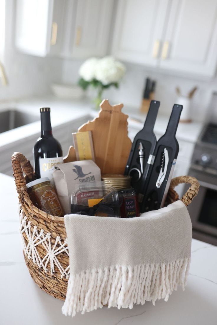 a wicker basket filled with wine bottles and kitchen utensils on a counter