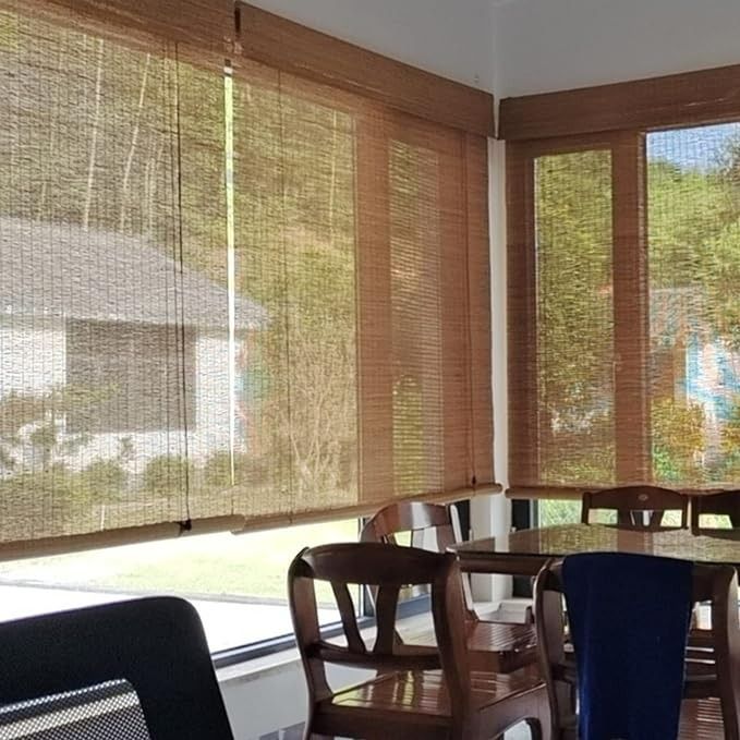 a dining room table and chairs in front of large windows with blinds on the outside