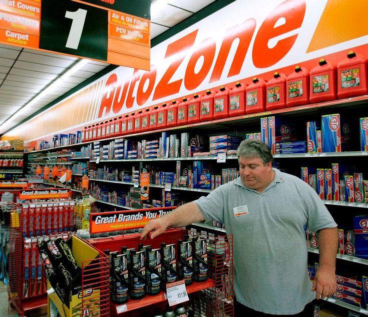 a man standing in front of a store shelf filled with items