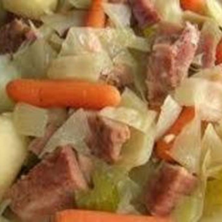 a plate with meat, carrots and celery on it