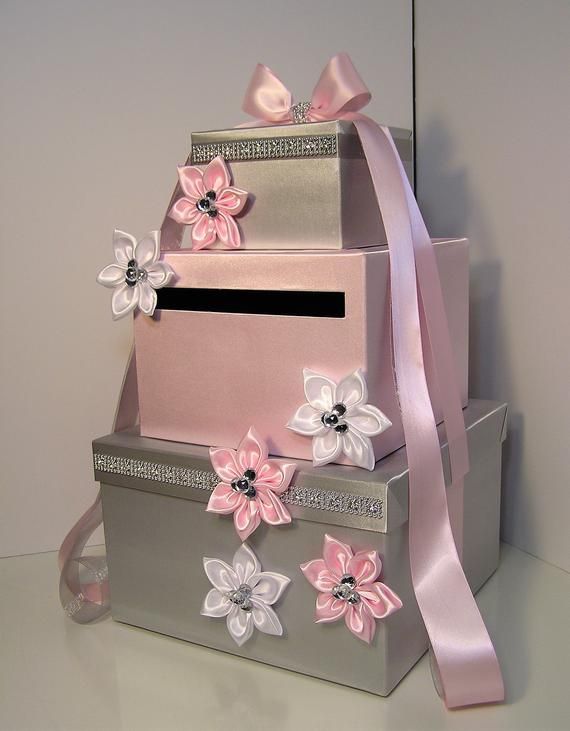 three stacked boxes with pink and white flowers on them