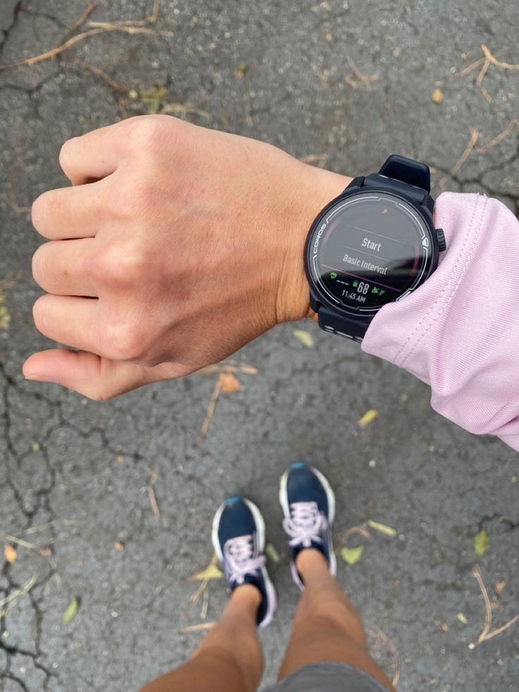 a person wearing a watch on their wrist with both hands in front of the camera