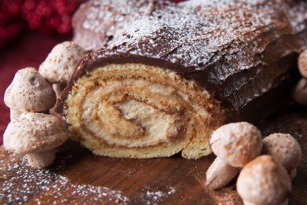 there is a chocolate roll with nuts on the table