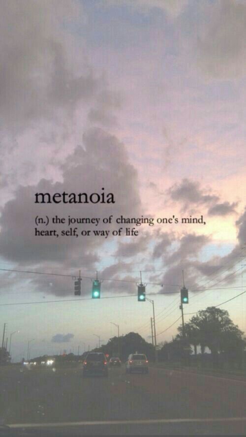 the sky is filled with clouds and green traffic lights that read, metanoia