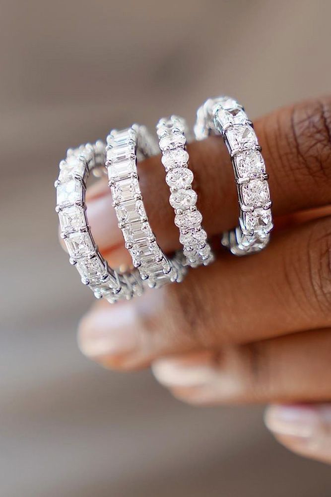 three diamond rings on top of each other in the palm of someone's hand