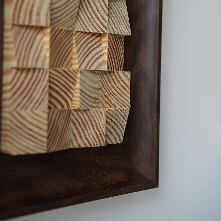 the wood is cut into squares and placed on the wall