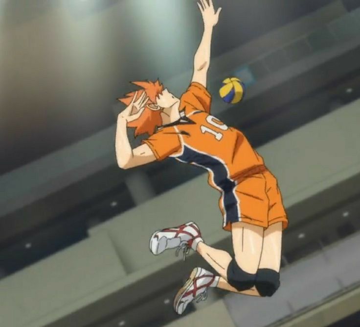 a person jumping up in the air with a volleyball on their feet and an orange shirt