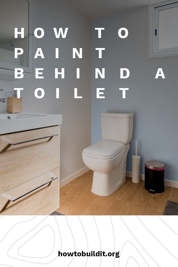 a white toilet sitting in a bathroom next to a wooden cabinet and sink with the words how to paint behind it