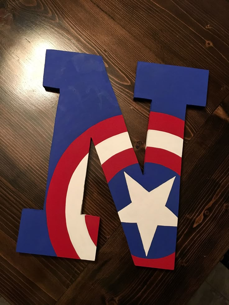 the letter n is made out of wood and has captain's shield painted on it