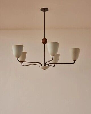 a chandelier hanging from the ceiling in a room with white walls and flooring