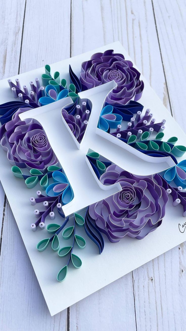 the letter k is made out of paper flowers