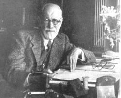 an old man sitting at a desk with a typewriter