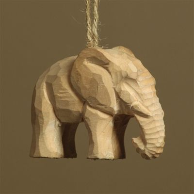 a wooden elephant ornament hanging from a rope on a brown background with the word,