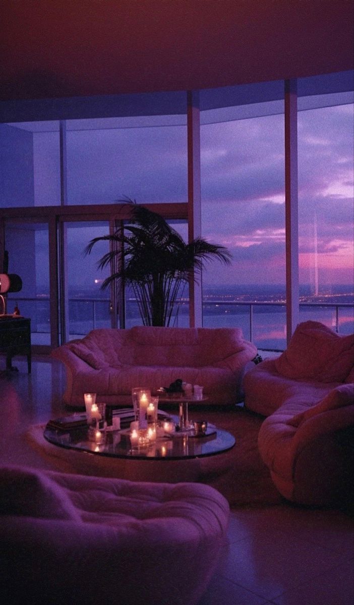 a living room filled with furniture and candles