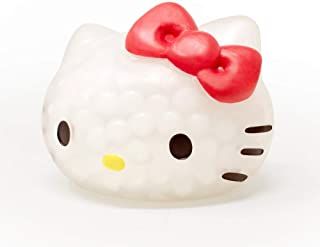 a hello kitty figurine with a red bow on its head