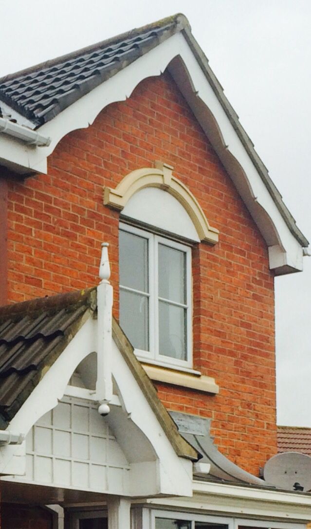 a red brick house with white trim and windows