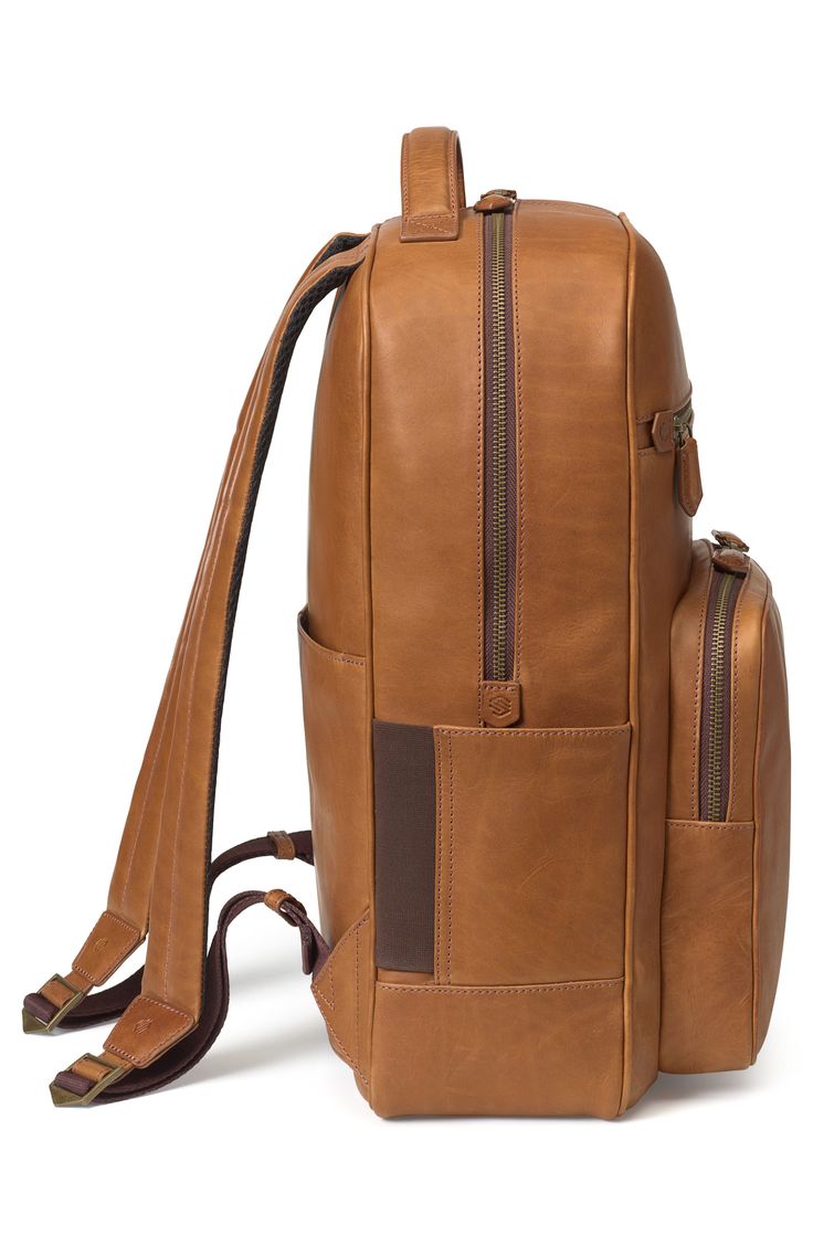 Debossed logo detailing and full-grain leather elevate a streamlined backpack outfitted with a spacious interior and multiple compartments for on-the-go wear. Lined Leather Imported Modern Backpack With Leather Trim For On-the-go, Luxury Leather Satchel Backpack For Travel, Luxury Brown Laptop Backpack, Luxury Leather Business Backpack With Leather Handles, Luxury Backpack With Leather Handles For Daily Use, Classic Brown Leather Travel Backpack, Modern Business Leather Backpack With Leather Trim, Classic Brown Leather Backpack For Travel, Modern Leather Backpack With Leather Trim For Business