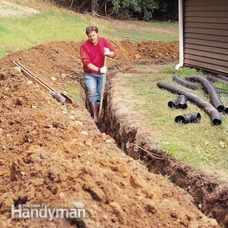 a man is digging in the ground with a shovel and water hoses behind him