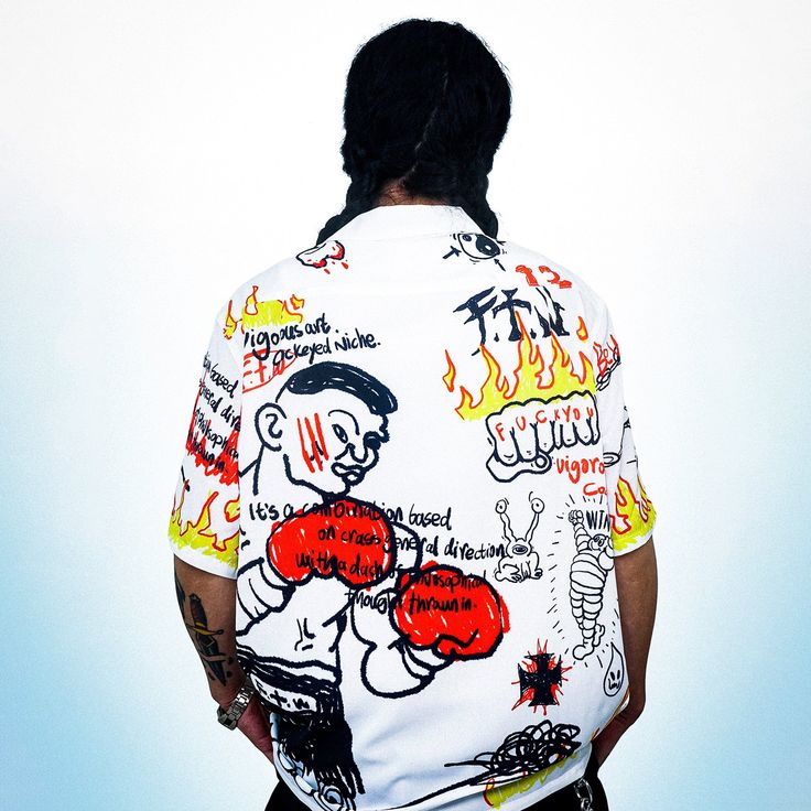 The Boxer Graffiti Half-Shirt delivers a dynamic mix of vintage style and bold artistry. Featuring an all-over boxing-themed graffiti print, this half-sleeve shirt brings an edgy, street-inspired aesthetic to any look. The button-up closure and premium fabric ensure both comfort and style, while the slightly oversized Hip Hop Relaxed Fit Tops With Graffiti Print, Hip Hop Style Relaxed Fit Graffiti Print Tops, Graffiti Print Short Sleeve Tops For Streetwear, Short Sleeve Tops With Graffiti Print For Streetwear, Streetwear Graffiti Print Graphic Tee Shirt, Urban Graffiti Print Shirt For Streetwear, Urban Shirt With Graffiti Print For Streetwear, Sporty Short Sleeve Tops With Graffiti Print, Hip Hop Graphic Shirt For Streetwear