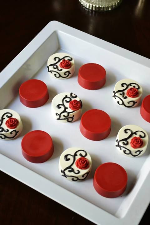 red and white cupcakes are arranged on a tray