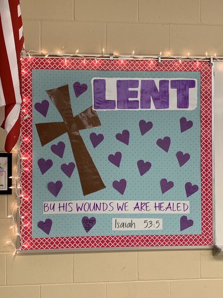 a bulletin board with a cross and hearts on it