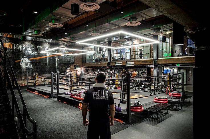 a man standing in front of a boxing ring