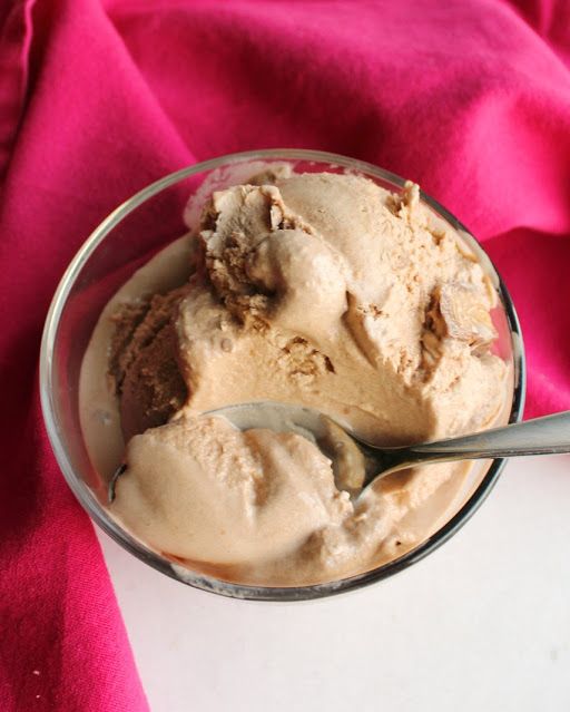 a bowl filled with ice cream on top of a pink cloth