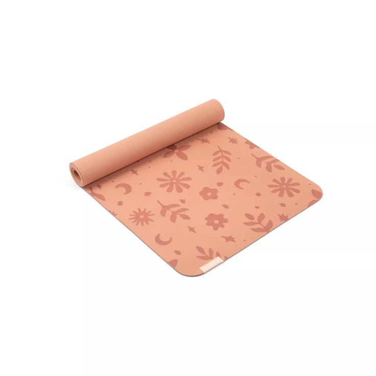 a yoga mat with pink flowers on it and a roll of paper in the middle