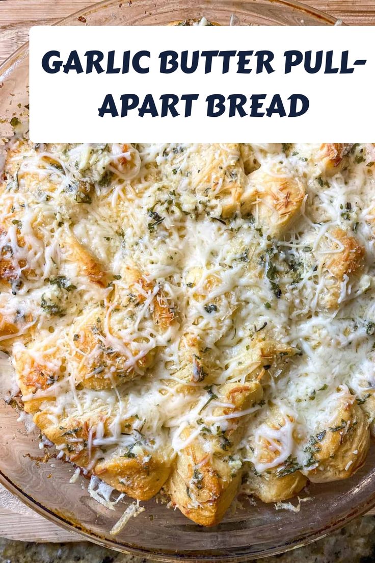 garlic butter pull apart appetizer bread on a glass platter with text overlay