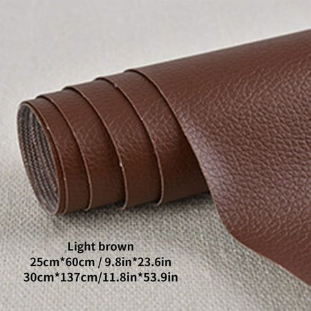 the brown leather is laid out on top of the white cloth, and it looks like it