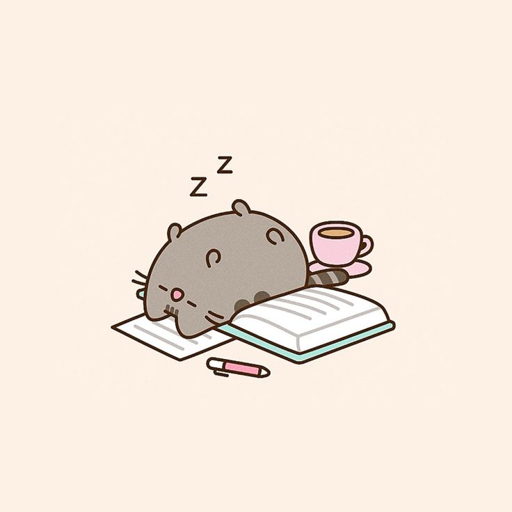 a cat sleeping on top of an open book next to a cup of coffee