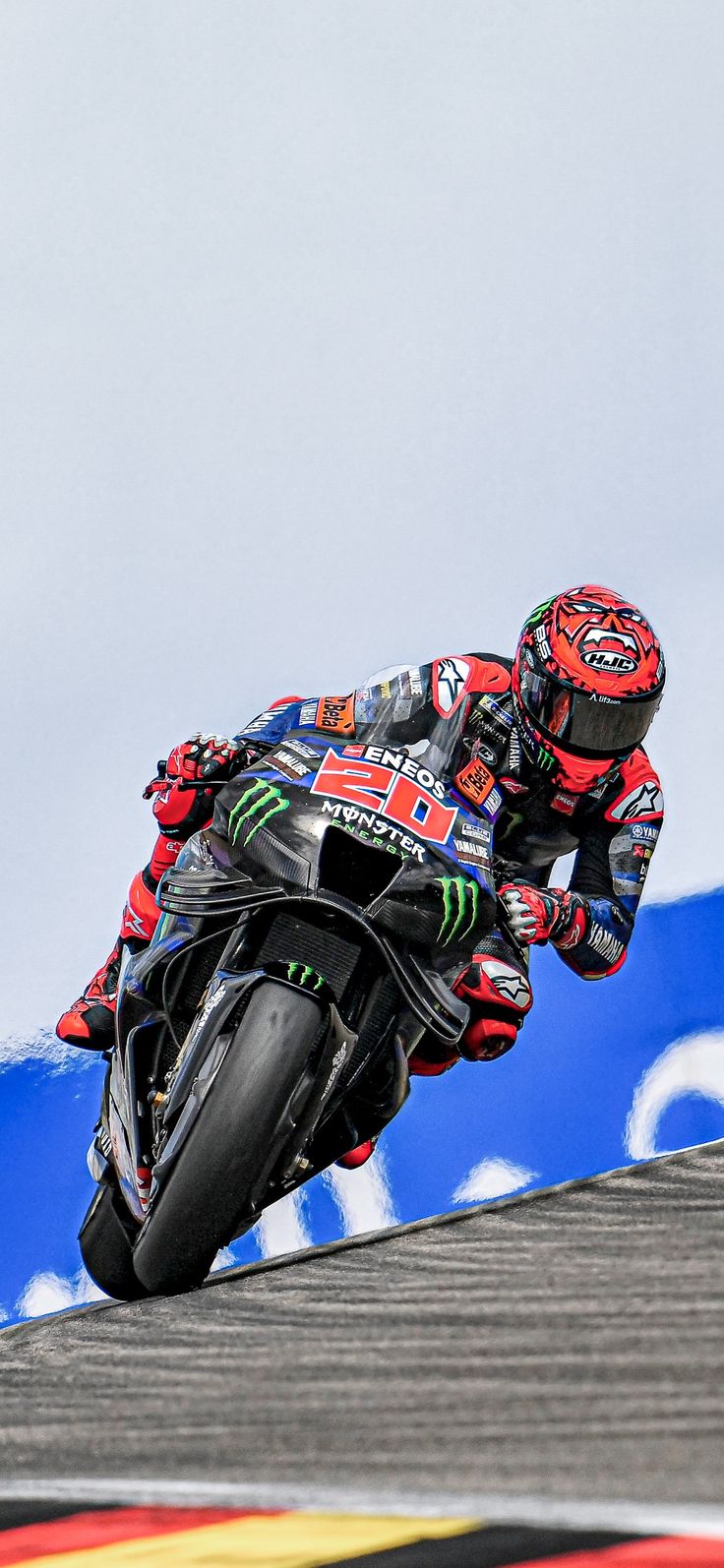 a man riding a motorcycle on top of a race track