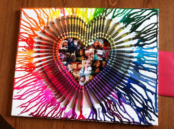 a heart made out of colored pencils on top of a wooden table