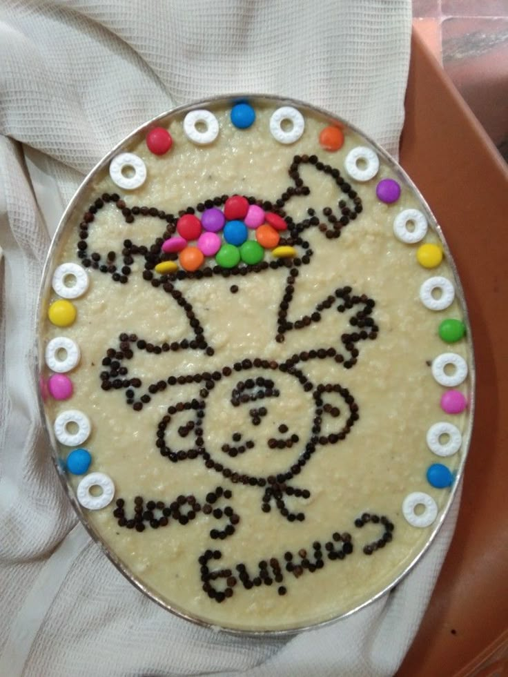 a cake that has been decorated to look like a cow with beads on its head