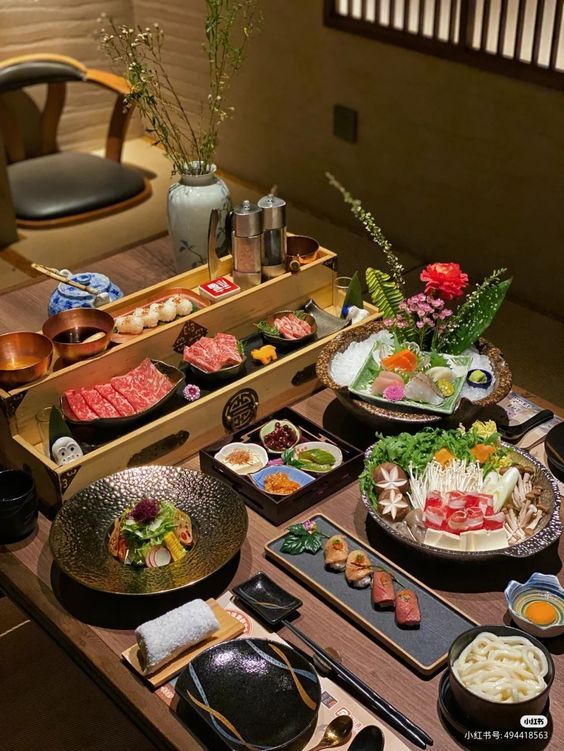 a wooden table topped with lots of different types of food