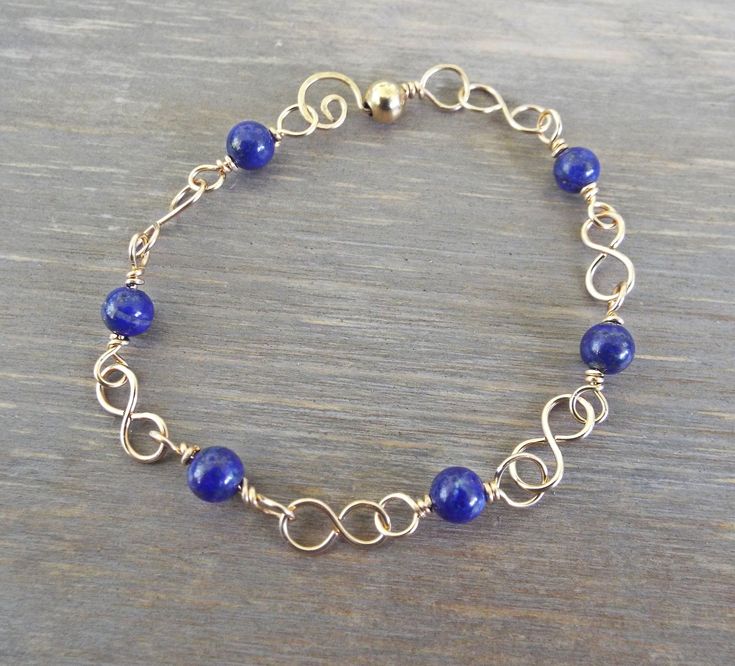 "Thank you for looking at RustandSalt. I truly appreciate your visit and taking the time to look around my shop. I hope you find something you like, and that speaks to you. Deep Blue Natural Lapis Lazuli Delicate Artisan Bracelet 14K Gold Filled. 6-7/8\" long bracelet. All gold filled wire and genuine Lapis Lazuli." Blue 14k Gold-filled Bracelet Jewelry, 14k Gold-filled Blue Bracelet, Blue 14k Gold Filled Bracelet Jewelry, 14k Gold Filled Blue Bracelet, Bracelet Or, Long Bracelet, Lapis Lazuli Bracelet, Artisan Bracelets, Lapis Lazuli