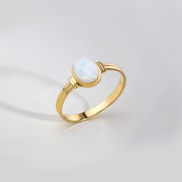 ABOUT PRODUCT  This 14K solid gold White  Opal Ring. The stackable ring is suitable for every finger, especially forefinger.  You can buy this trendy, minimalist ring as a birthday, anniversary, Valentine's Day or Mother's Day gift. It is also suitable as an engagement or promise ring for your girlfriend.  We produce and package our jewelry carefully for you. Our aim is to produce minimalist jewelry for daily use. If you want to add a special note we can write for you and put into the package. I Fine Jewelry Opal Ring Oval Cabochon Birthstone, Fine Jewelry Opal Oval Cabochon Ring, Yellow Gold Oval Opal Ring, Classic Gold Moonstone Ring With Oval Cabochon, Oval Hallmarked 14k Gold Moonstone Ring, Classic Oval Opal Ring With Polished Finish, Hallmarked Oval Moonstone Fine Jewelry Ring, Oval Hallmarked Moonstone Ring In Fine Jewelry Style, Fine Jewelry Hallmarked Oval Moonstone Ring