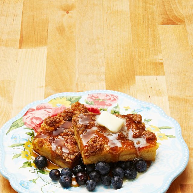 two pieces of bread on a plate with blueberries and cheese sitting on top of it