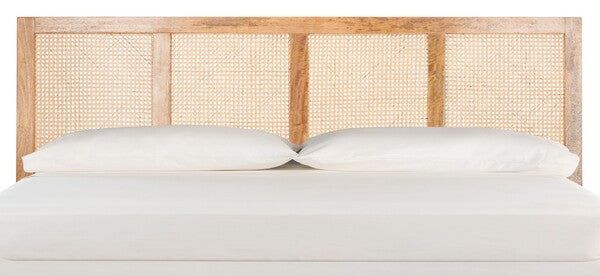 a bed with white sheets and pillows in front of a wooden headboard that has wicker panels on it