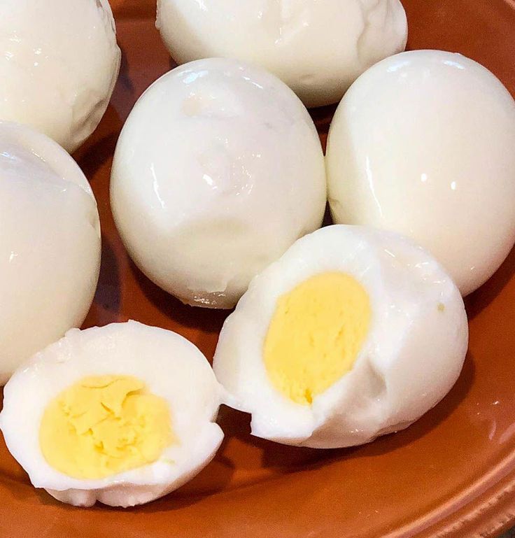 an orange plate topped with hard boiled eggs