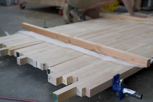 some wood planks are laying on the ground and ready to be cut into pieces