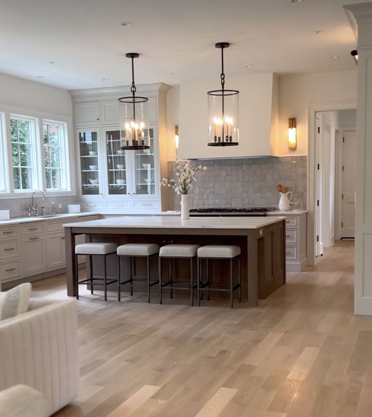 a large kitchen with an island in the middle and lots of counter space on one side