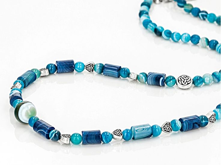 Artisan Collection of Ireland™ Multi-Shape Blue Agate Stainless Steel 24.5" Beaded Necklace. Measures Approximately 0.48"W. Lobster Claw Closure with 1" Extender. Color, Shape and Pattern May Vary. Blue Hand-strung Necklace For Gift, Single Strand Agate Jewelry Gift, Adjustable Single Strand Agate Jewelry, Blue Hand-strung Necklaces As Gift, Blue Hand-strung Necklace As A Gift, Spiritual Blue Necklaces With Polished Beads, Blue Amulet Style Jewelry With Polished Beads, Blue Agate Jewelry For Jewelry Making, Blue Amulet Style Necklace With Natural Stones