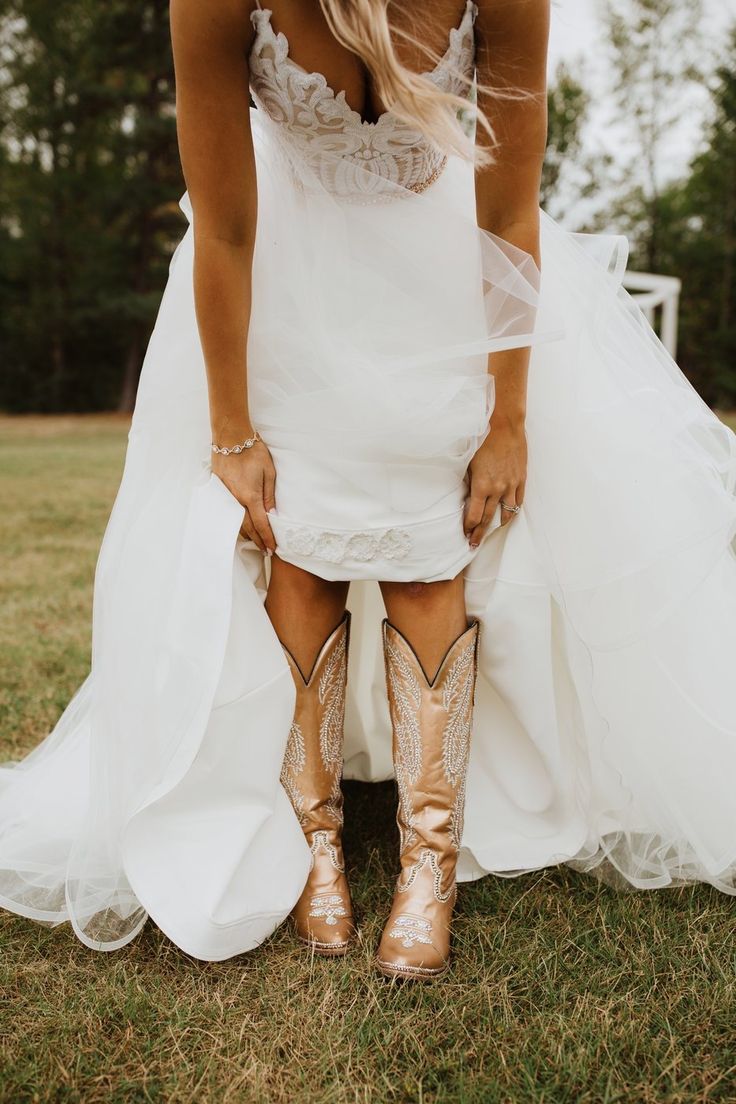 a woman in white dress and cowboy boots