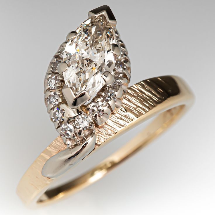 a fancy ring with an oval cut diamond in the center